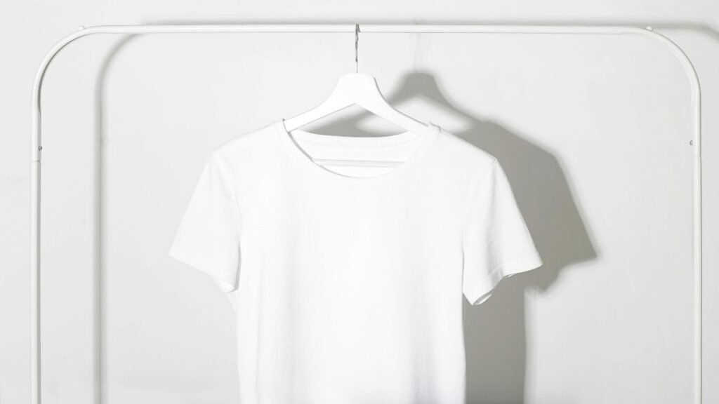 White t-shirt hanging on rack